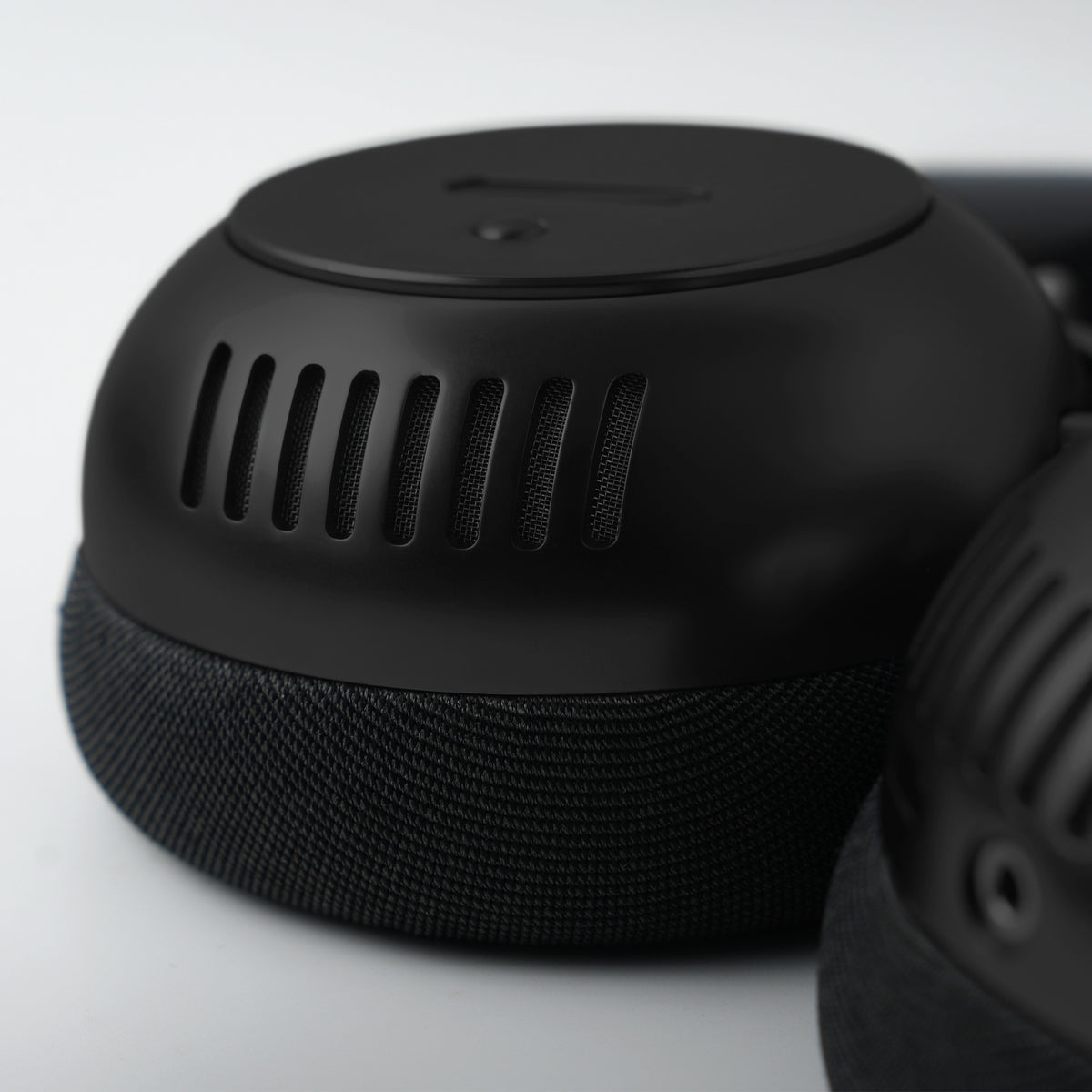 Close-up of black headphones on a light gray background